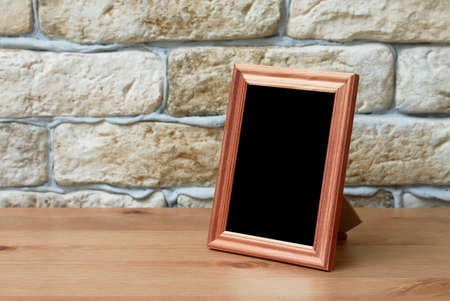 old photo frame on the wooden tableの写真素材