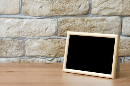 old photo frame on the wooden tableの写真素材
