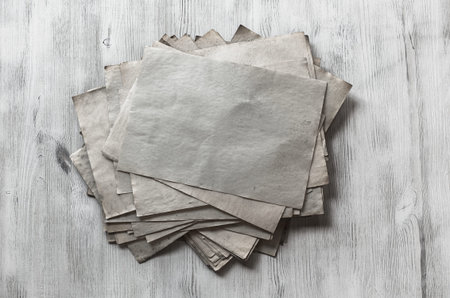 stack of old papers on white wooden backgroundの写真素材