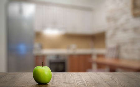green apple on old wooden table in the bedroomの写真素材
