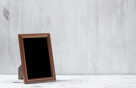 photo frame on old white tableの写真素材
