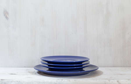 Blue plates on white tableの写真素材