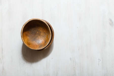 empty wooden bowls on white tableの写真素材
