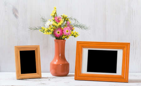photo frames and flowers on old white tableの写真素材