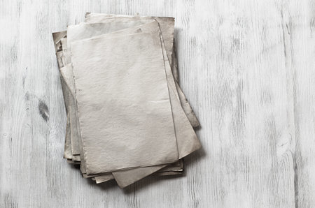 stack of old papers on white wooden background