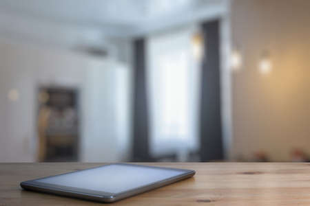 tablet on wooden table in the living roomの写真素材
