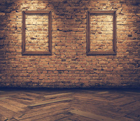 old grunge interior with blank frames against wall, retro filteredの写真素材