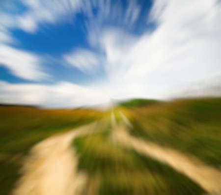 country road in the fields, with slight motion blurの写真素材