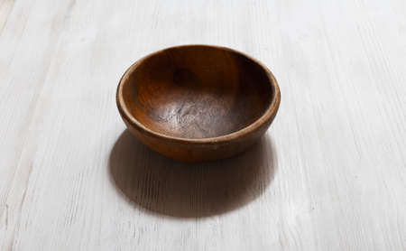 empty wooden bowl on white tableの写真素材