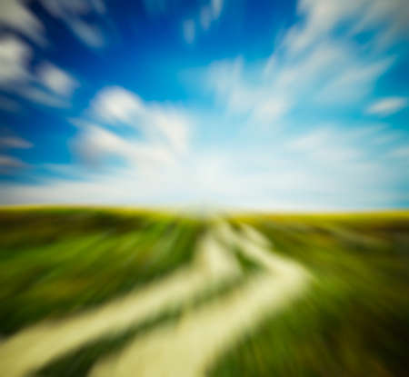country road in the fields, with slight motion blurの写真素材
