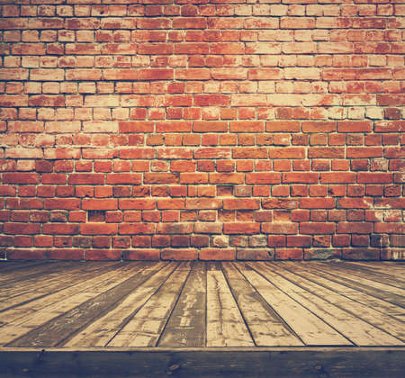 old room with brick wall, vintage background, retro film filteredの写真素材