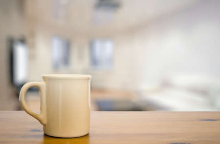 mug on old vintage wooden table in the living roomの写真素材