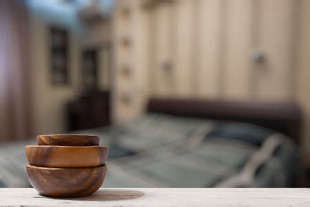 stack of empty wooden bowls on old wooden table in the bedroomの写真素材