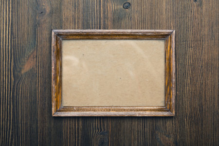 wooden photo frame on old wooden wall