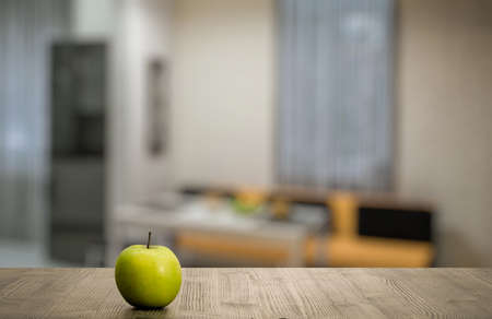 green apple on wooden table in the living roomの写真素材