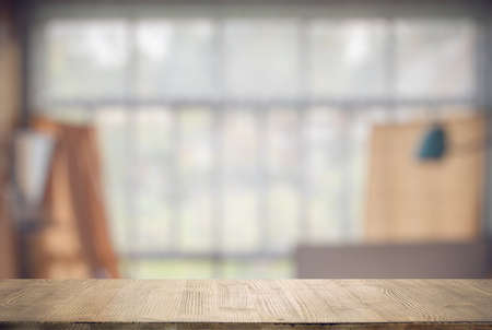 vintage wooden table in old room with big windowsの写真素材