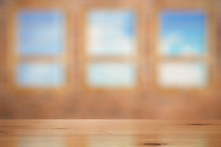 vintage wooden table in old room with big windows