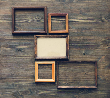 old frames on wooden wall