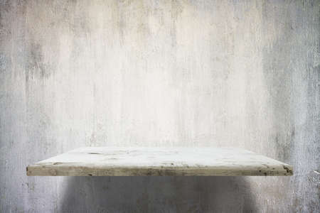 empty shelves on concrete wallの写真素材