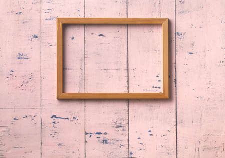 vintage photo frame on old pink wooden wallの写真素材