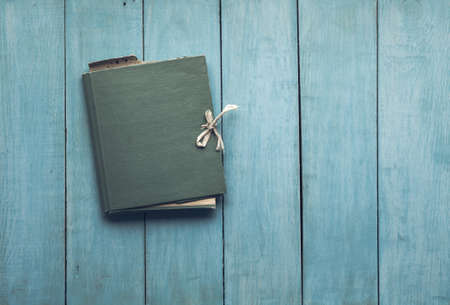 retro folder on old blue wooden backgroundの写真素材