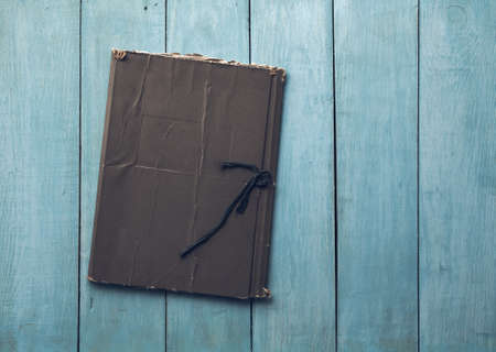 retro folder on old blue wooden backgroundの写真素材