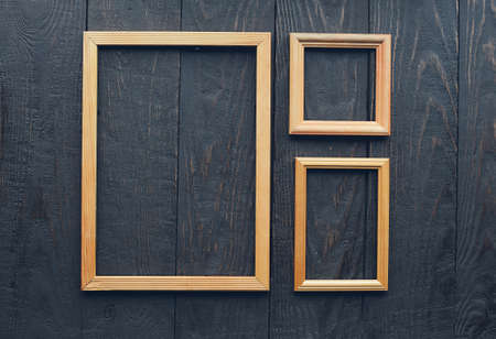 vintage frames on old wooden wallの写真素材