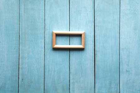old wooden photo frame on blue wooden wallの写真素材
