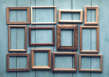 old wooden frames on old blue wallの写真素材