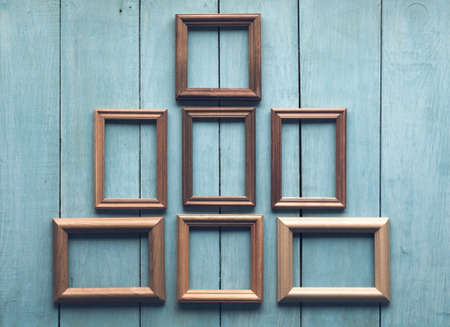 old wooden frames on old blue wallの写真素材