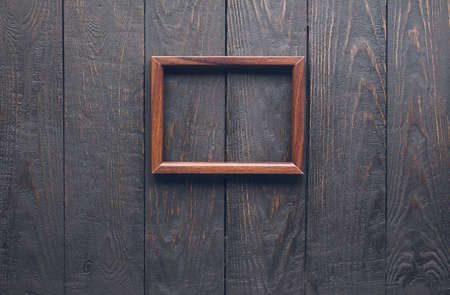 wooden photo frame on old wooden wallの写真素材