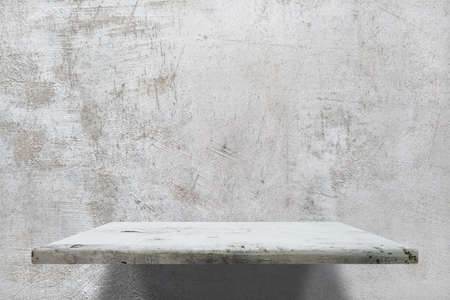 empty shelves on concrete wallの写真素材