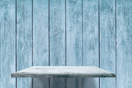 empty shelves on blue wooden wallの写真素材