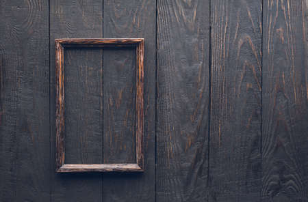 wooden photo frame on old wooden wallの写真素材