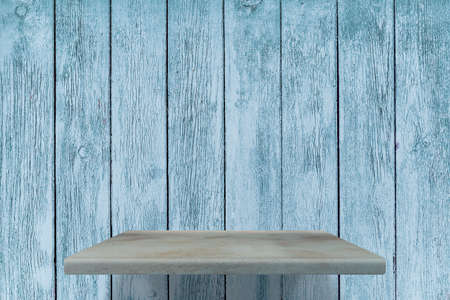 empty shelves on blue wooden wallの写真素材