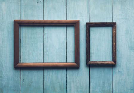 old wooden frames on old blue wallの写真素材