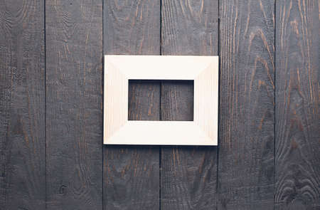 wooden photo frame on old wooden wallの写真素材