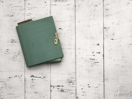 retro folder on old white wooden backgroundの写真素材