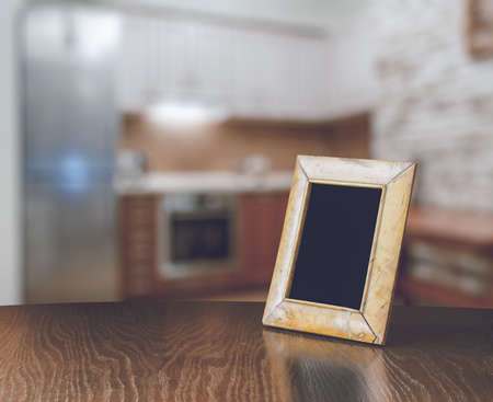 old photo frame on the wooden table  in the kitchenの写真素材
