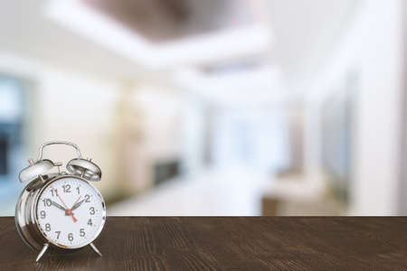 clock on wooden table in the living roomの写真素材