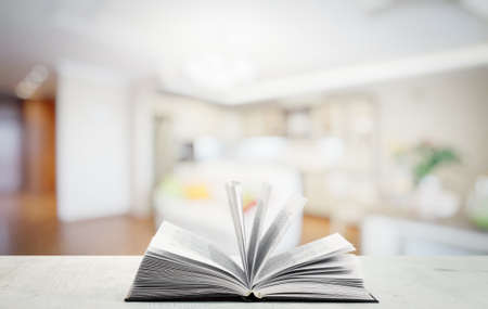 open book on white wooden table in the living roomの写真素材