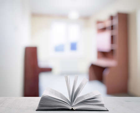 open book on white wooden table in the living roomの写真素材