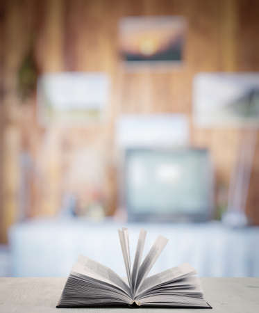 open book on white wooden table in the living roomの写真素材