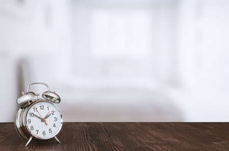 clock on wooden table in the bedroomの写真素材