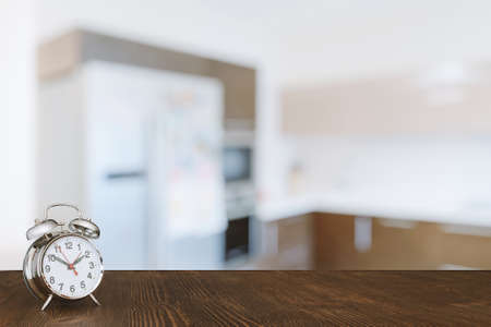 clock on wooden table in the kitchenの写真素材