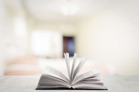 open book on white wooden table in the bedroomの写真素材