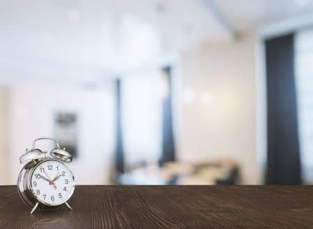 clock on wooden table in the living roomの写真素材