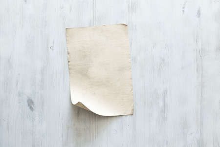 old paper on blue wooden wall, retro backgroundの写真素材