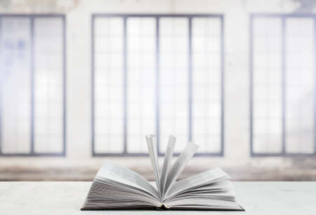 open book on white table in old room with big windowsの写真素材