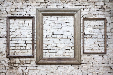 old photo frames on brick wallの写真素材